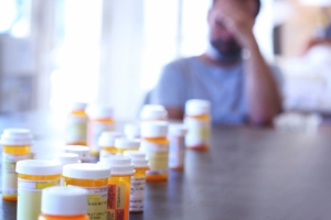 multiple pill bottles representing drug charges and trafficking cases
